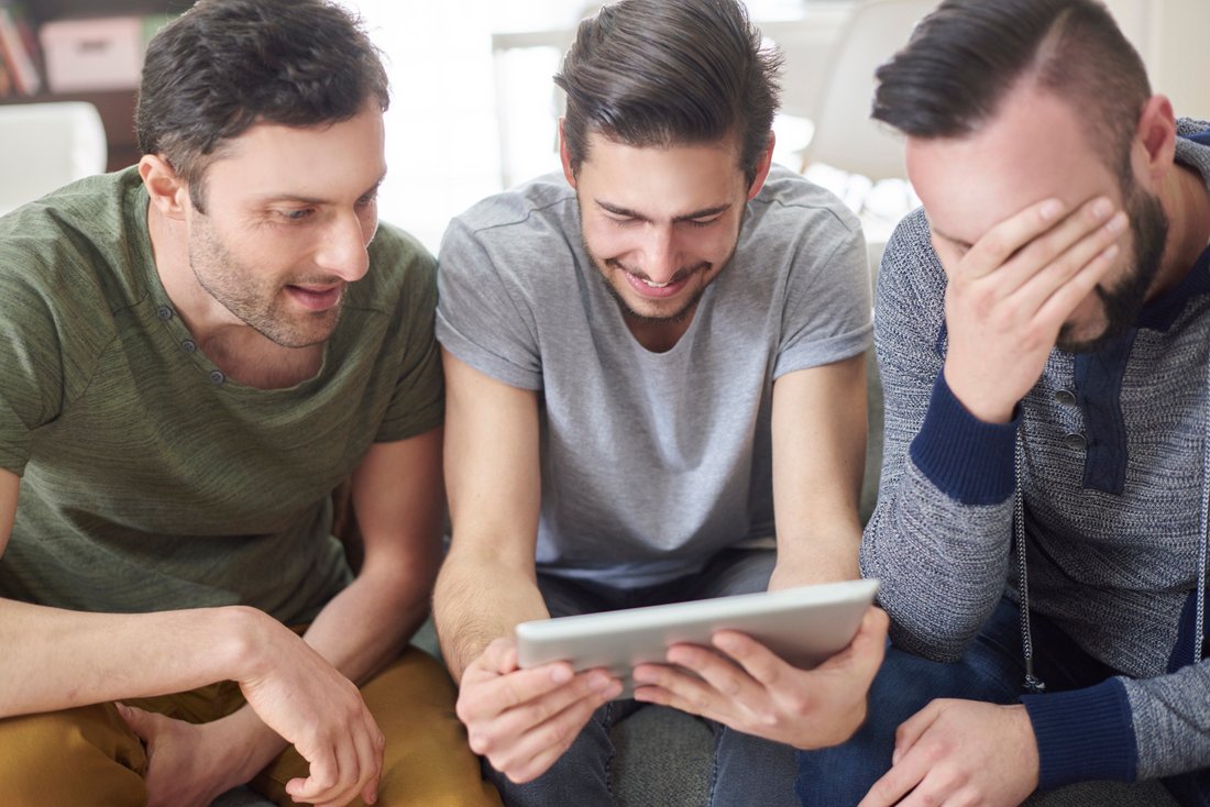 friends browsing photos from their old times